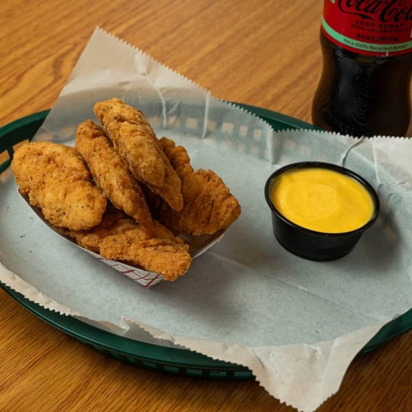 Phillys Cafe & Deli chicken tenders with dipping sauce and a Coca-Cola Zero Sugar bottle.